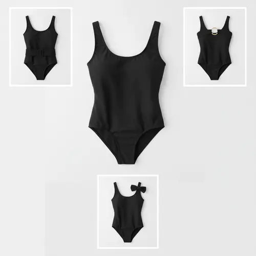 Un bañador de una pieza noir stylisé avec une ceinture amovible, un anneau et un nœud pour montrer comment les accessoires détachables modifient son look.